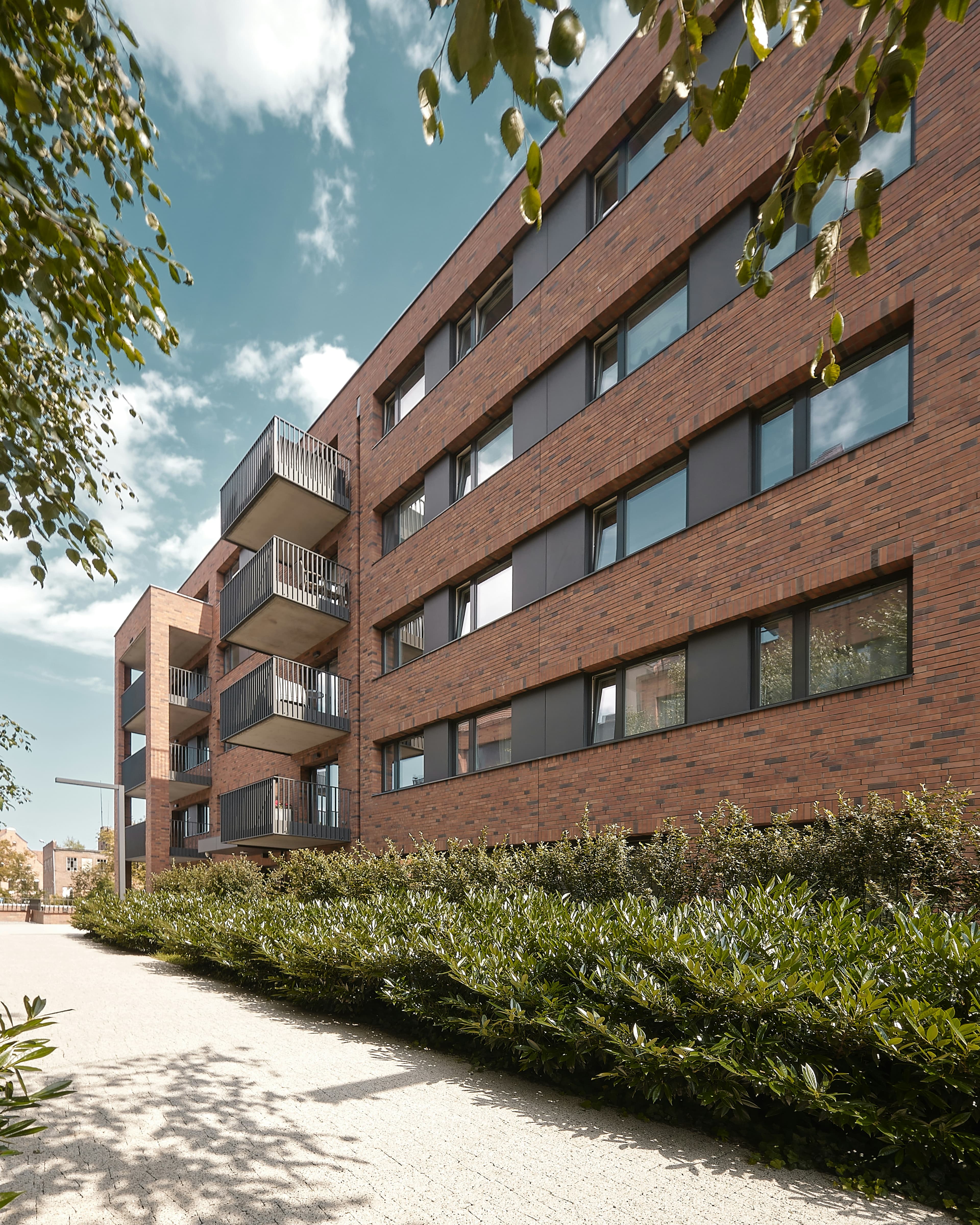 Modern brick multifamily apartment building, one of the best passive income investments 2026 for accredited investors