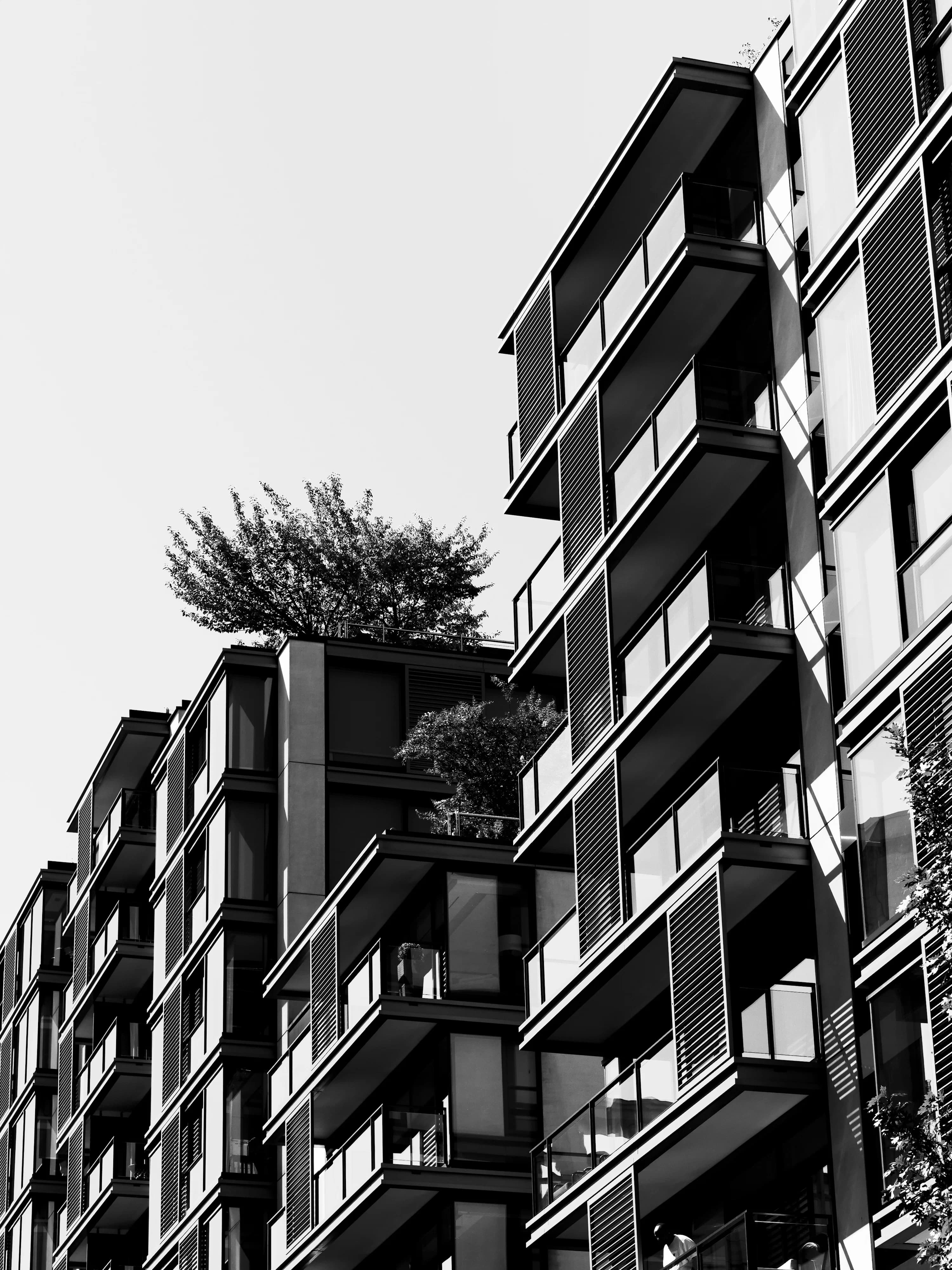 Modern multifamily apartment building exterior with balconies, representing multifamily syndication returns by project type